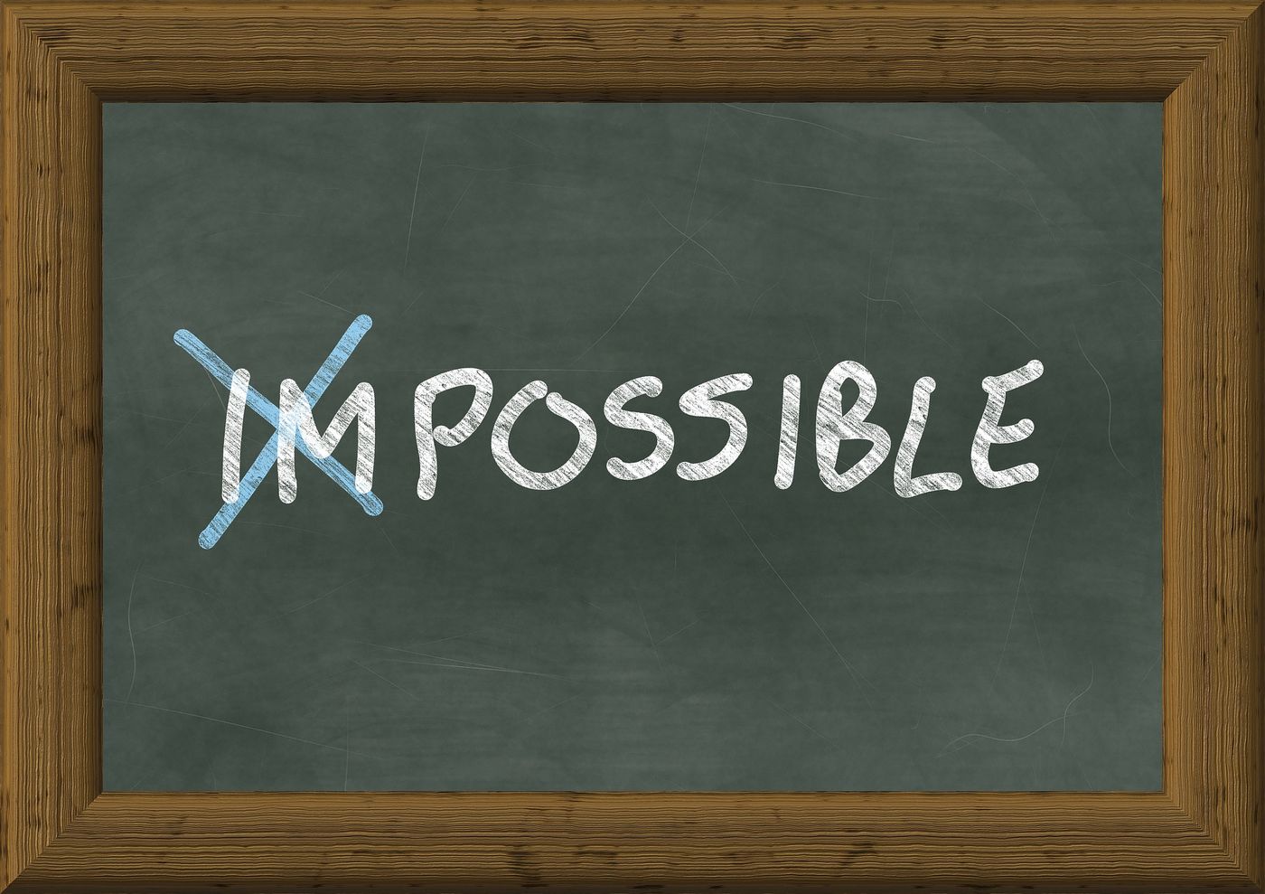 Tafel mit dem Wort IMpossible – Symbol für Transformation von festgefahrenen zu lösbaren Situationen